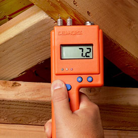 Using moisture meter to check moisture in wood beams